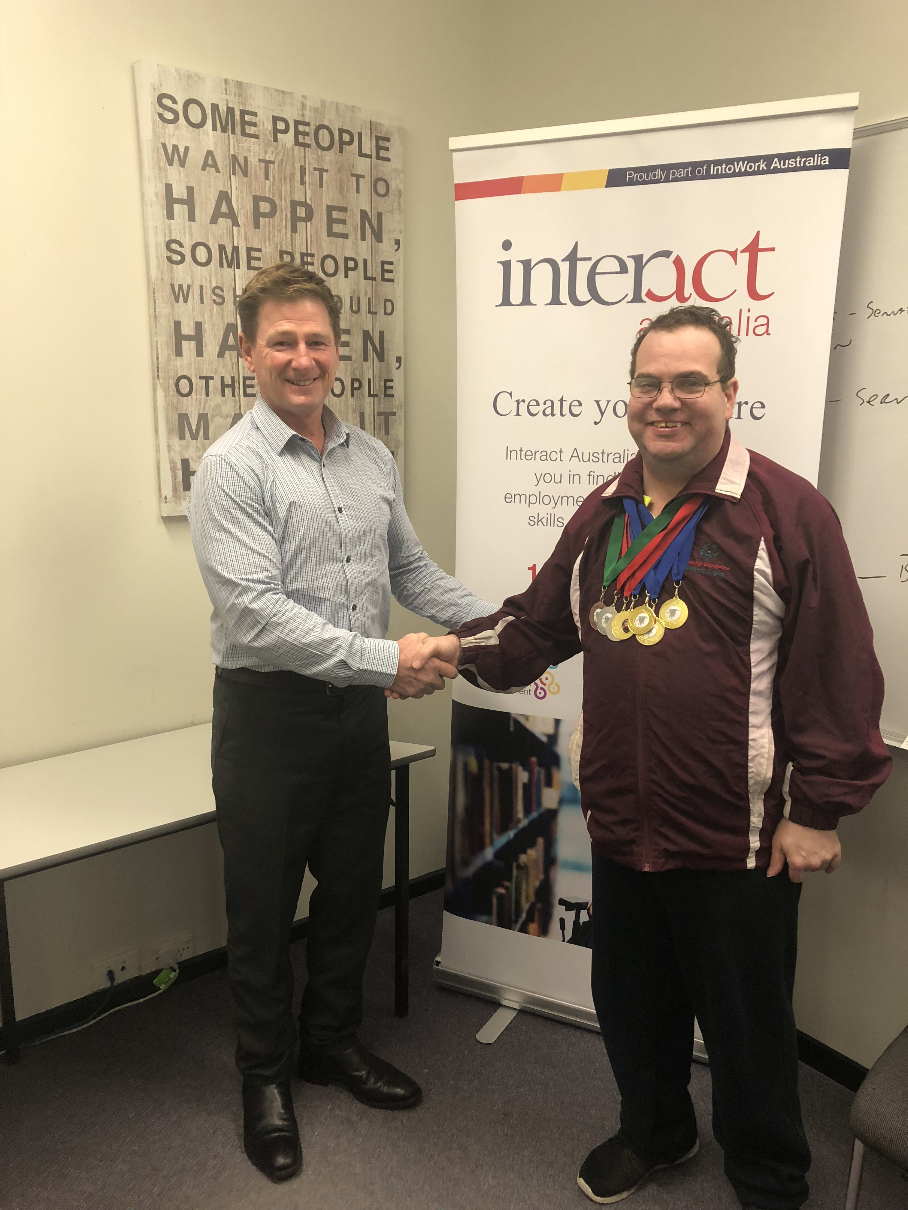 Darryn Perry, Interact Australia’s Performance and Partnership Leader in Hobart, is proudly pictured here with Tom who has donned the 7 medals (4 gold, 2 silvers and 1 bronze) he won at the recent Tenpin Bowling Australia disability championships.